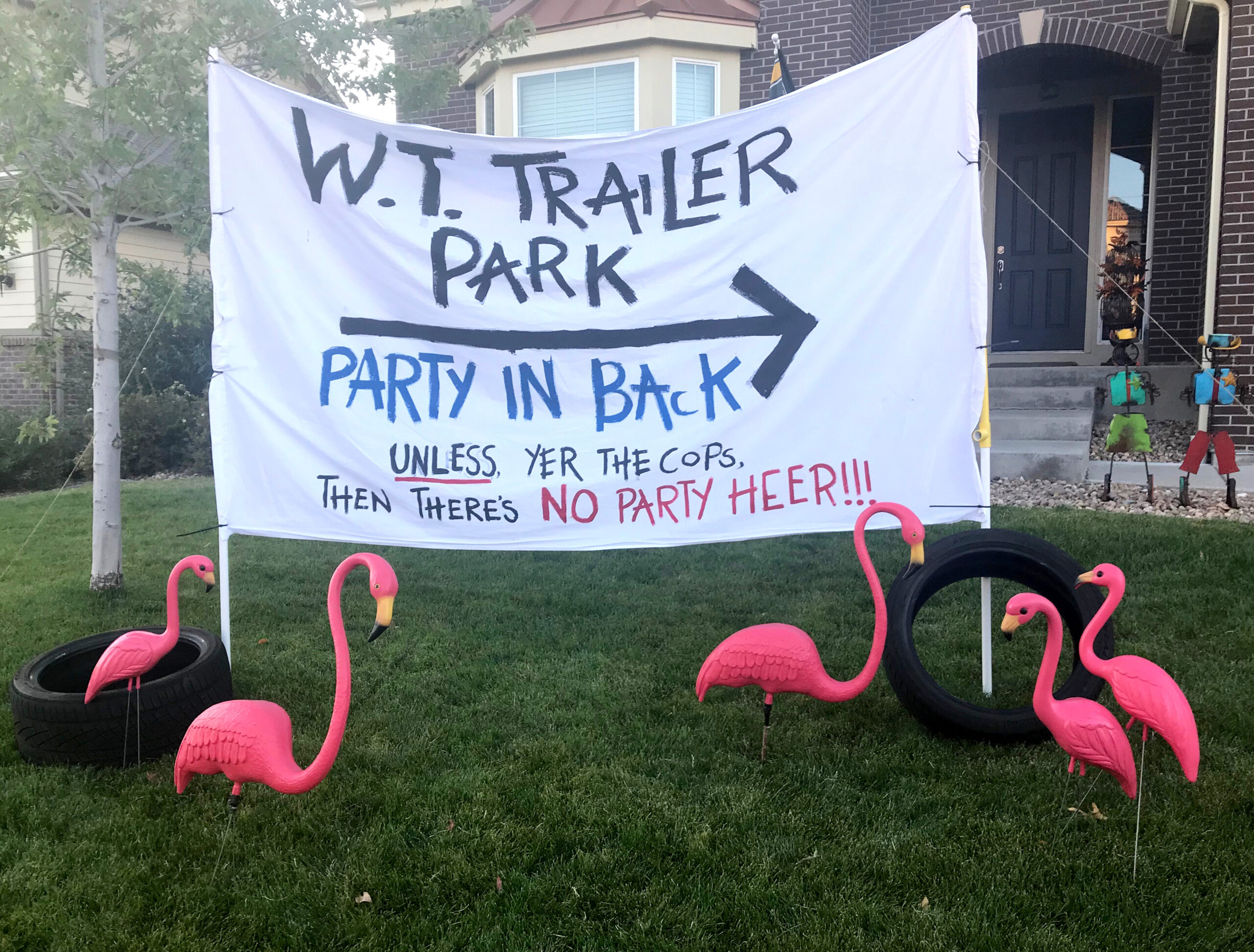 a sign with pink flamingos