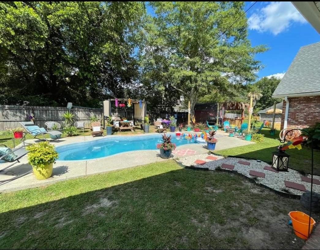 a backyard with a pool and trees