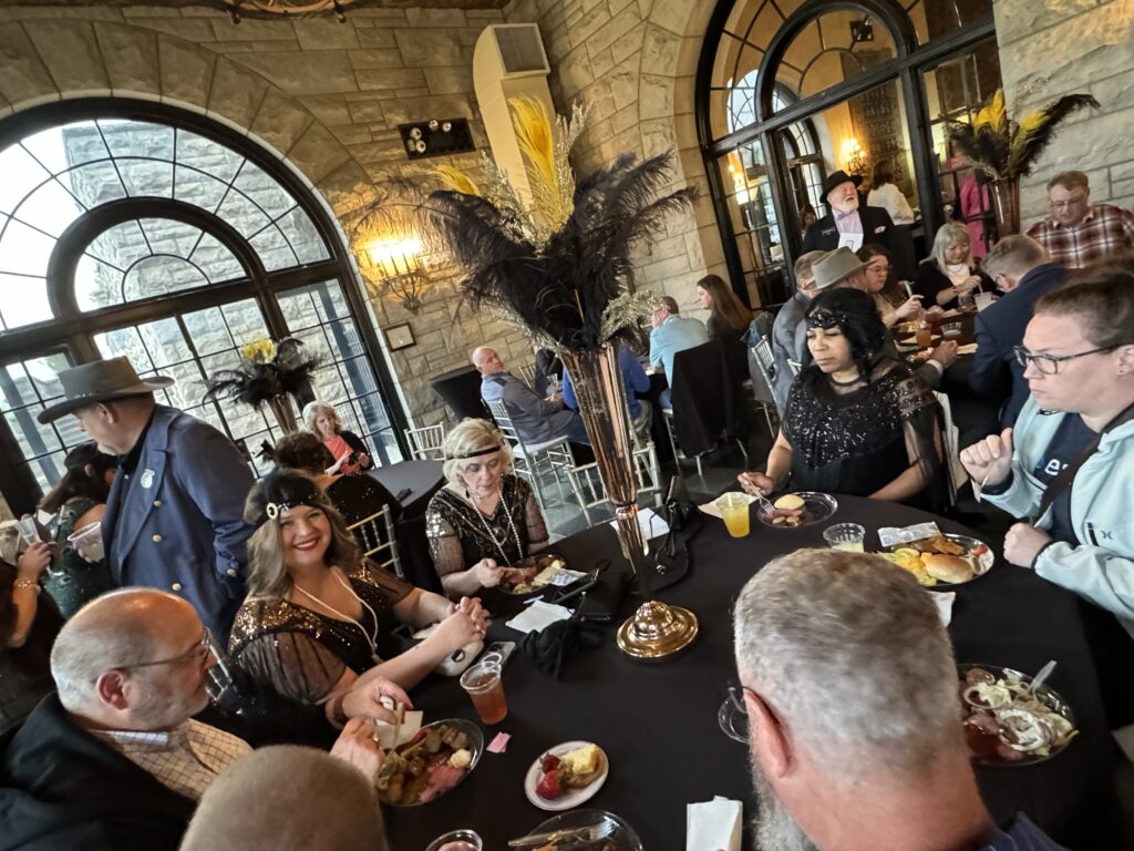 Partygoers gathered together in Gatsby-style outfits celebrating the night