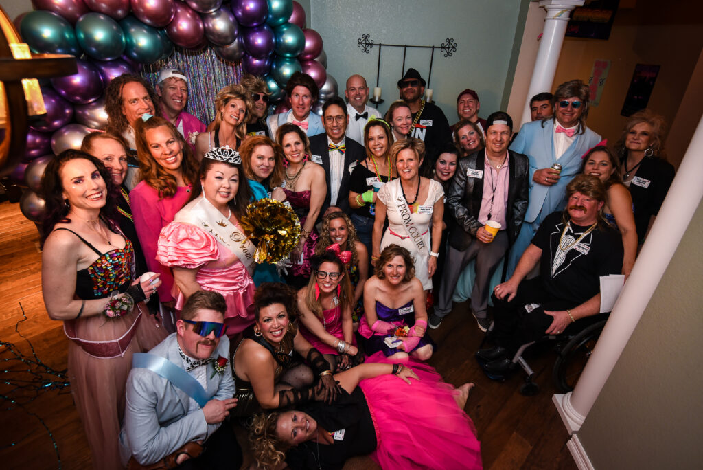 A group of friends engaged in a murder mystery party, dressed in themed costumes.