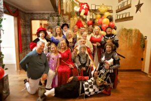 Guests dressed in costumes having fun at a Night of Mystery murder mystery party.