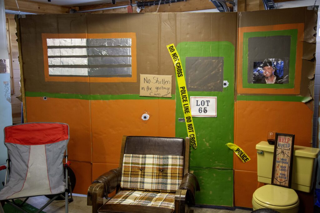 Murder mystery party entrance with themed sign and curtain