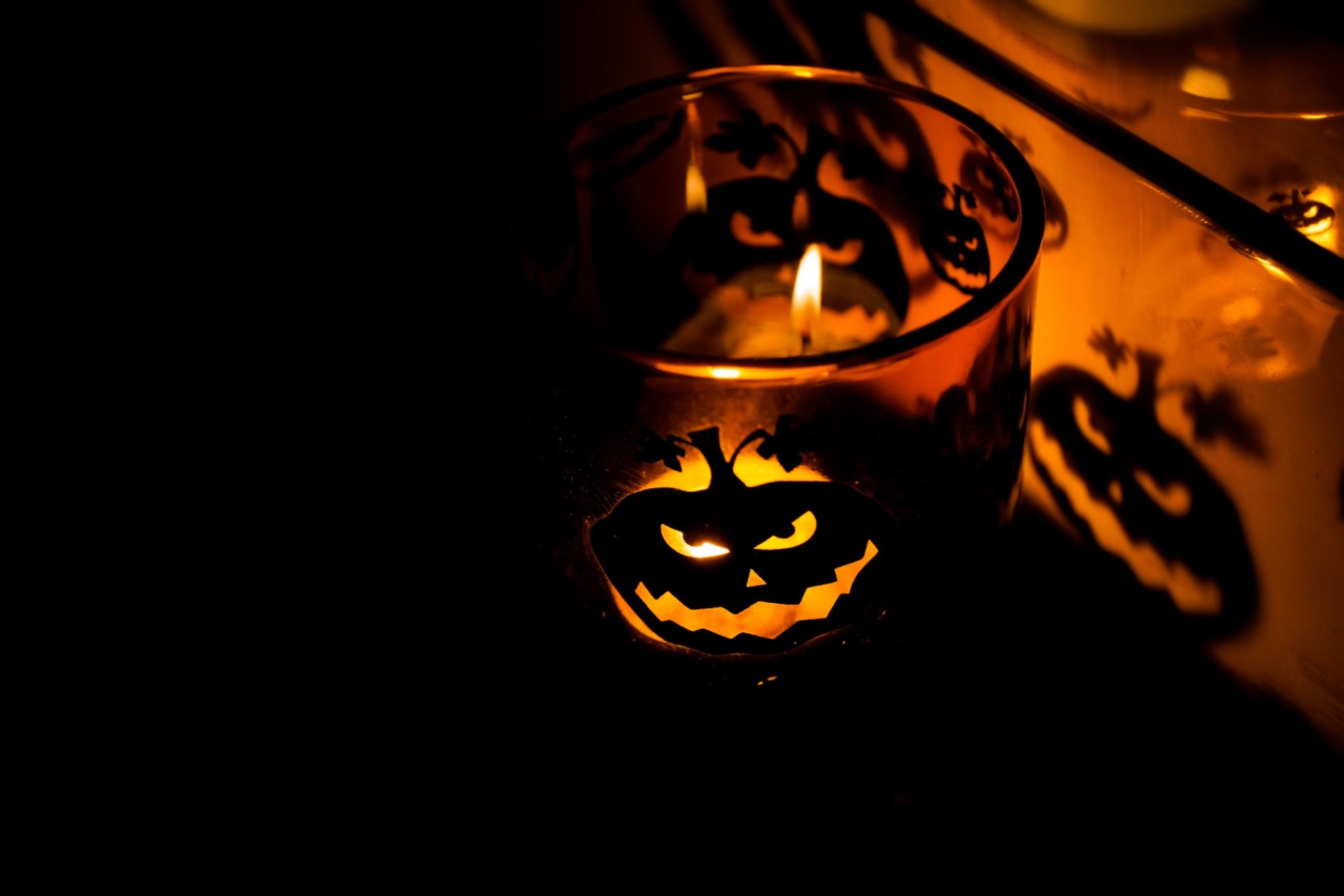 Spooky Halloween decorations lit by candlelight.