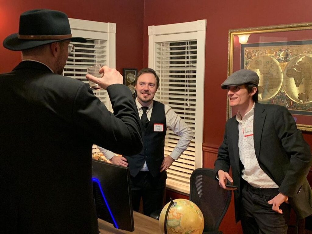 Coworkers participating in Quarterly Killing office murder mystery team-building event