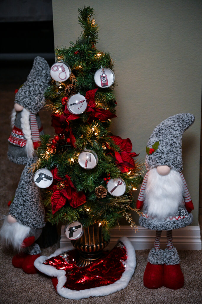 Christmas tree with clues and evidence tags for a holiday mystery game.