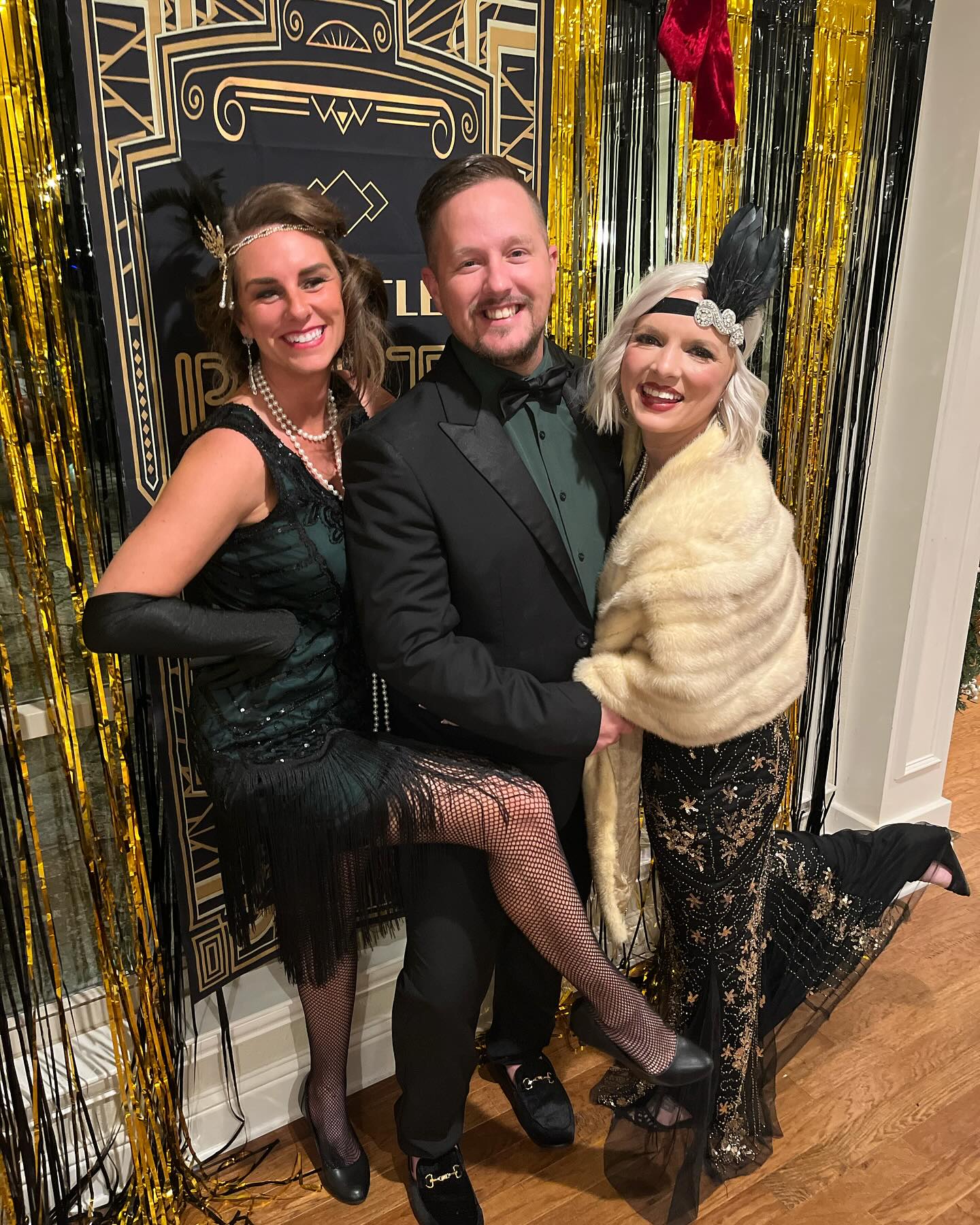 Guests dressed as flapper, mobster, and bartender at a 1920s murder mystery party.