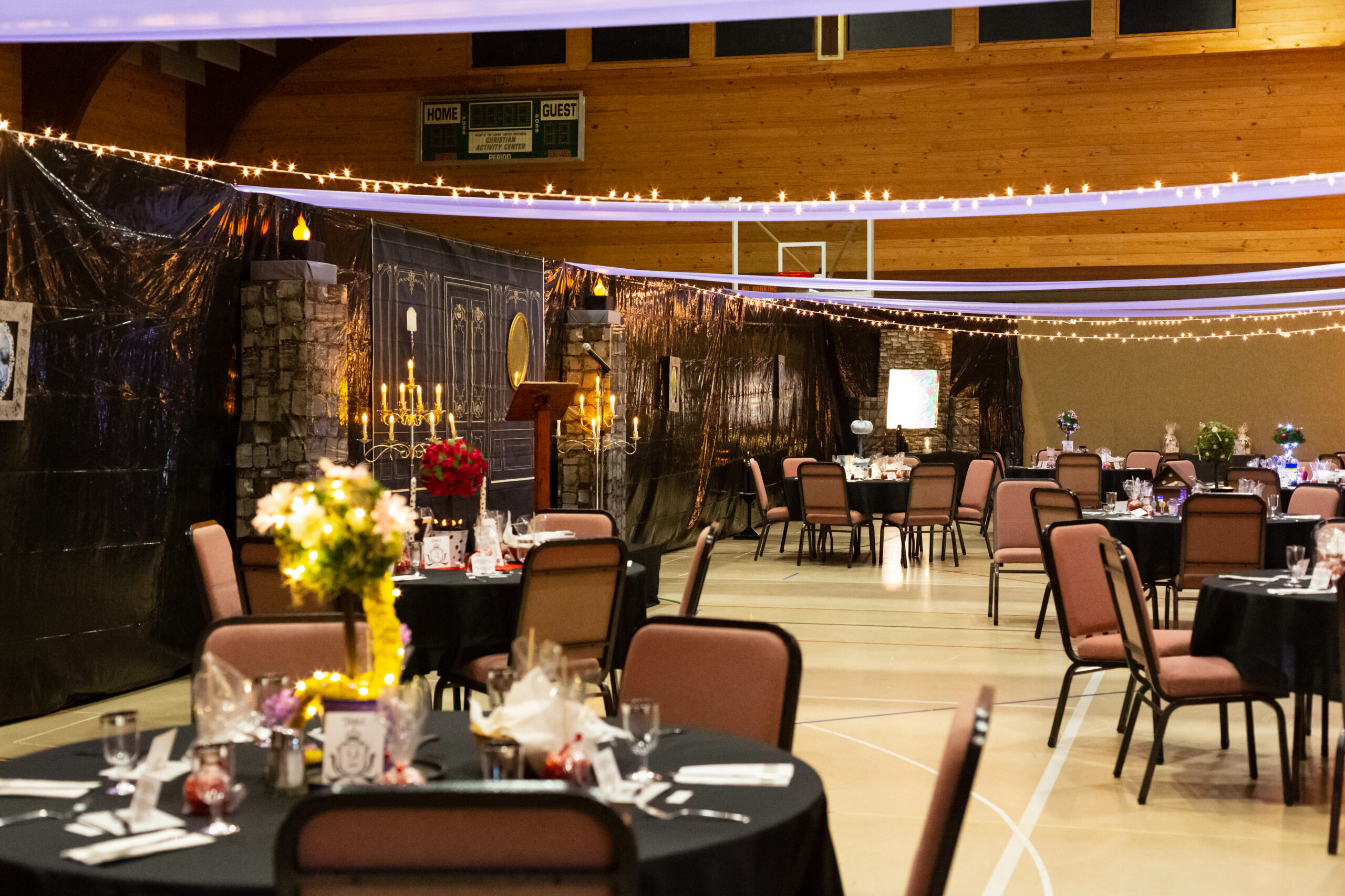 Guests attending a ticketed murder mystery party at a business venue, dressed in character and interacting during the event