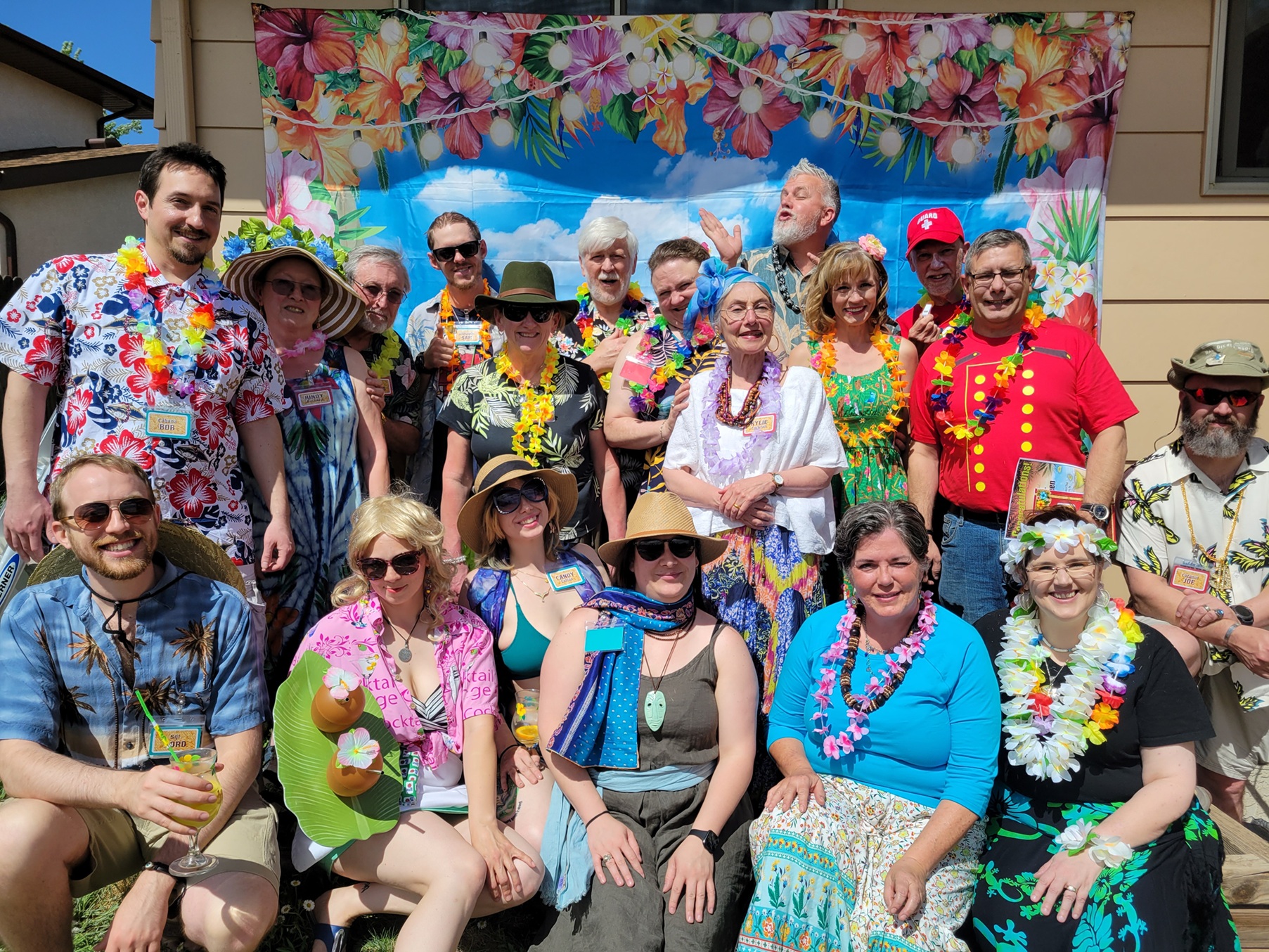 Guests in tropical costumes enjoying a beach-themed murder mystery game.