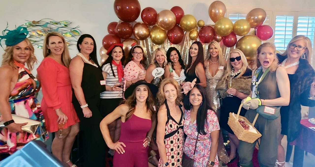 Women posing in gold and red backdrops