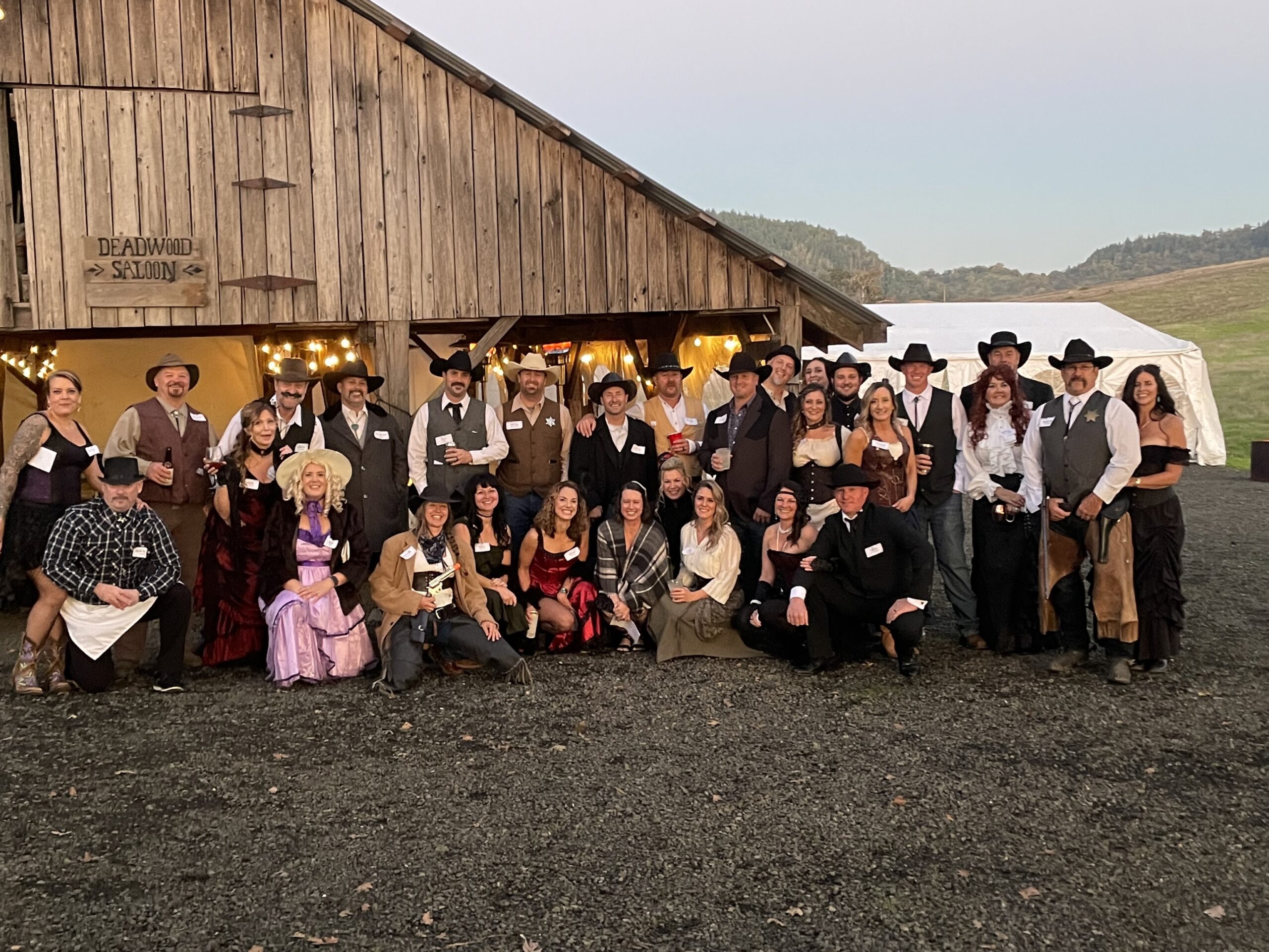 Guests attending a ticketed murder mystery party at a business venue, dressed in character and interacting during the event