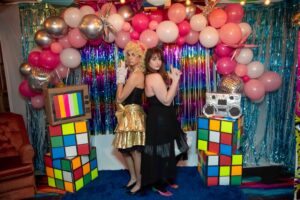 Night of Mystery | 80s Party Ideas: Outfits, Music, Decor, And Games Women Posing In Theme At A Party For Adults